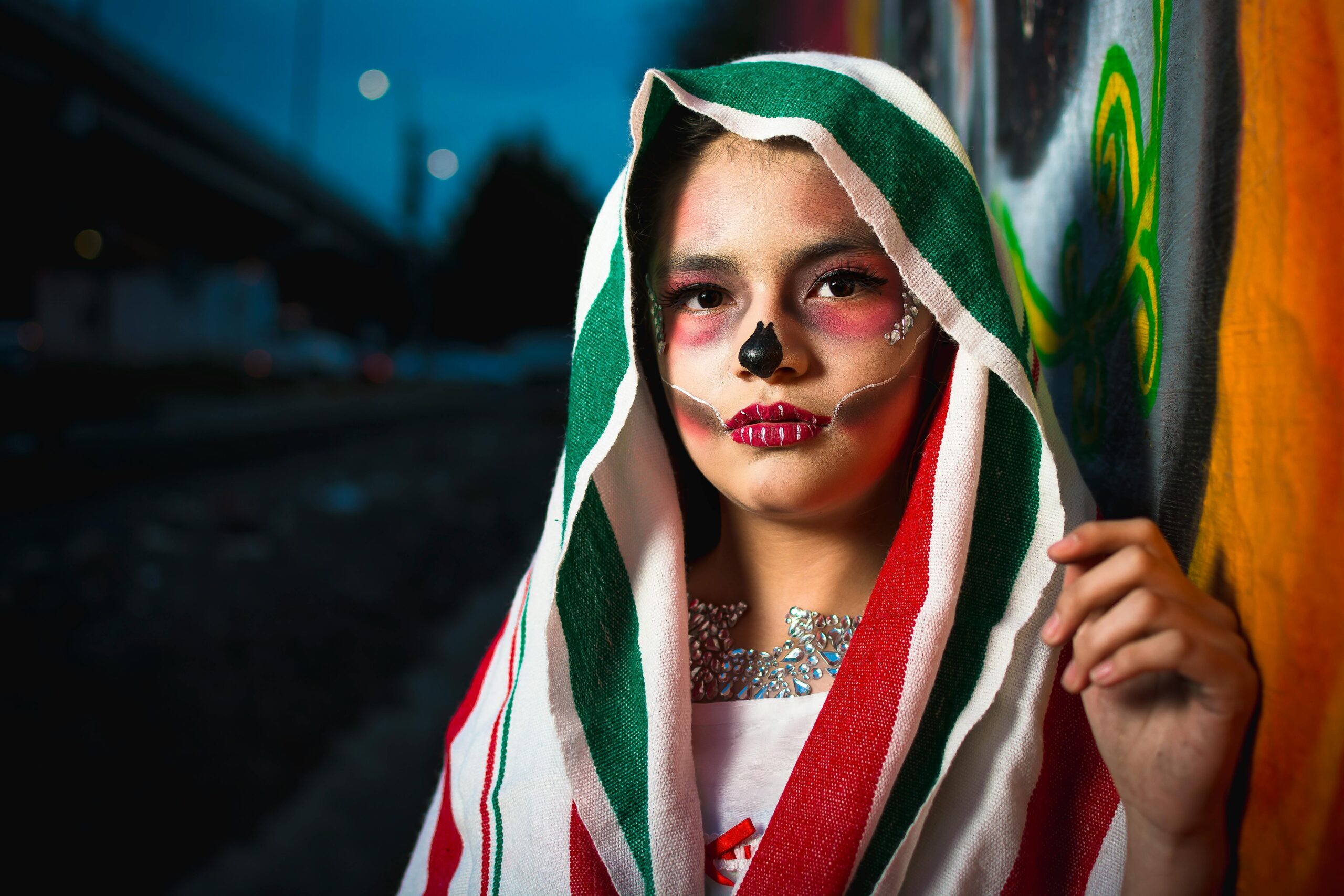 Young woman with sugar skull makeup during Dia de los Muertos in Toluca, Mexico. Vivid cultural expression.